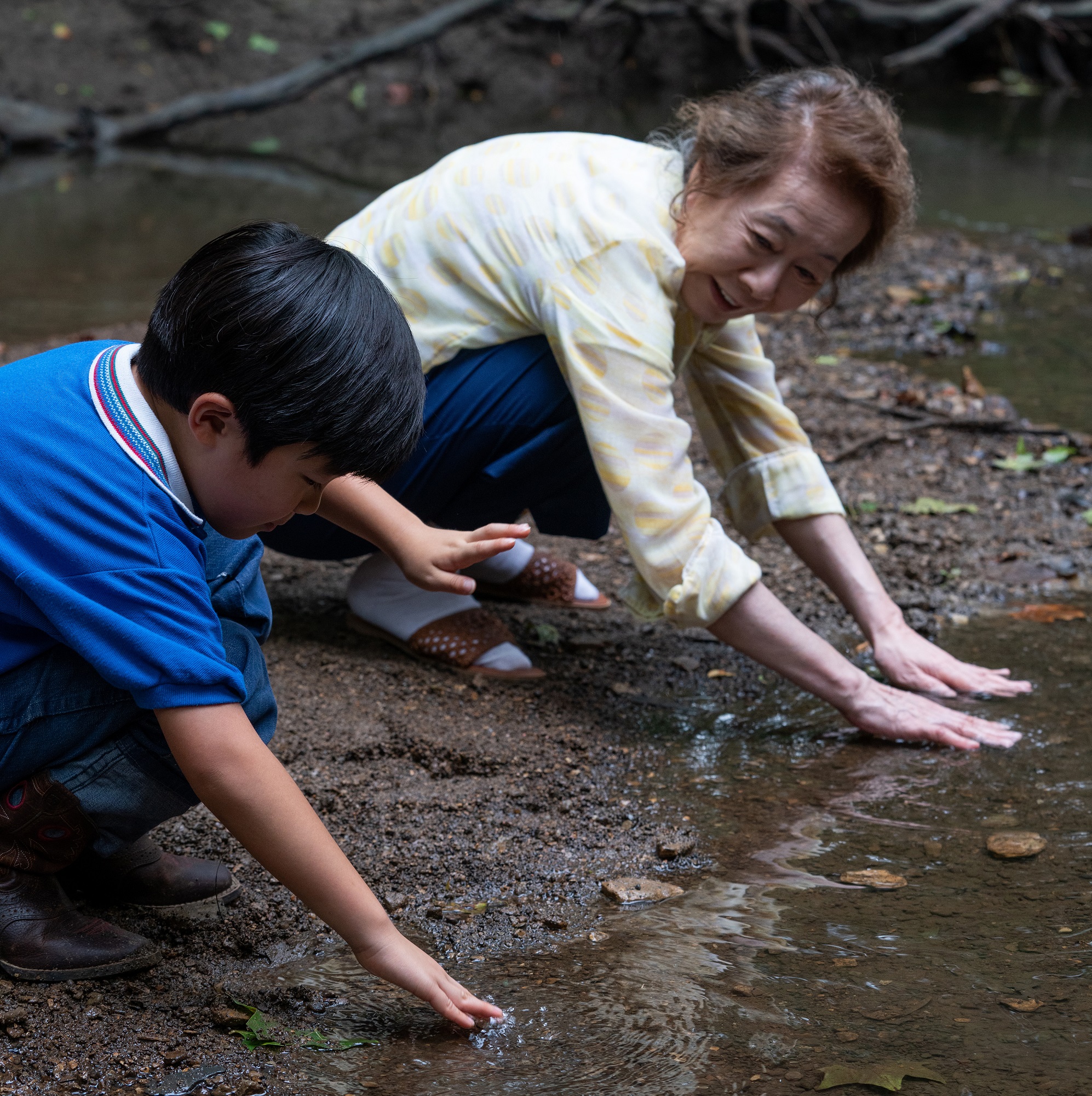 Minari: Alan S. Kim and Yuh-Jung Youn gather minari at the creek