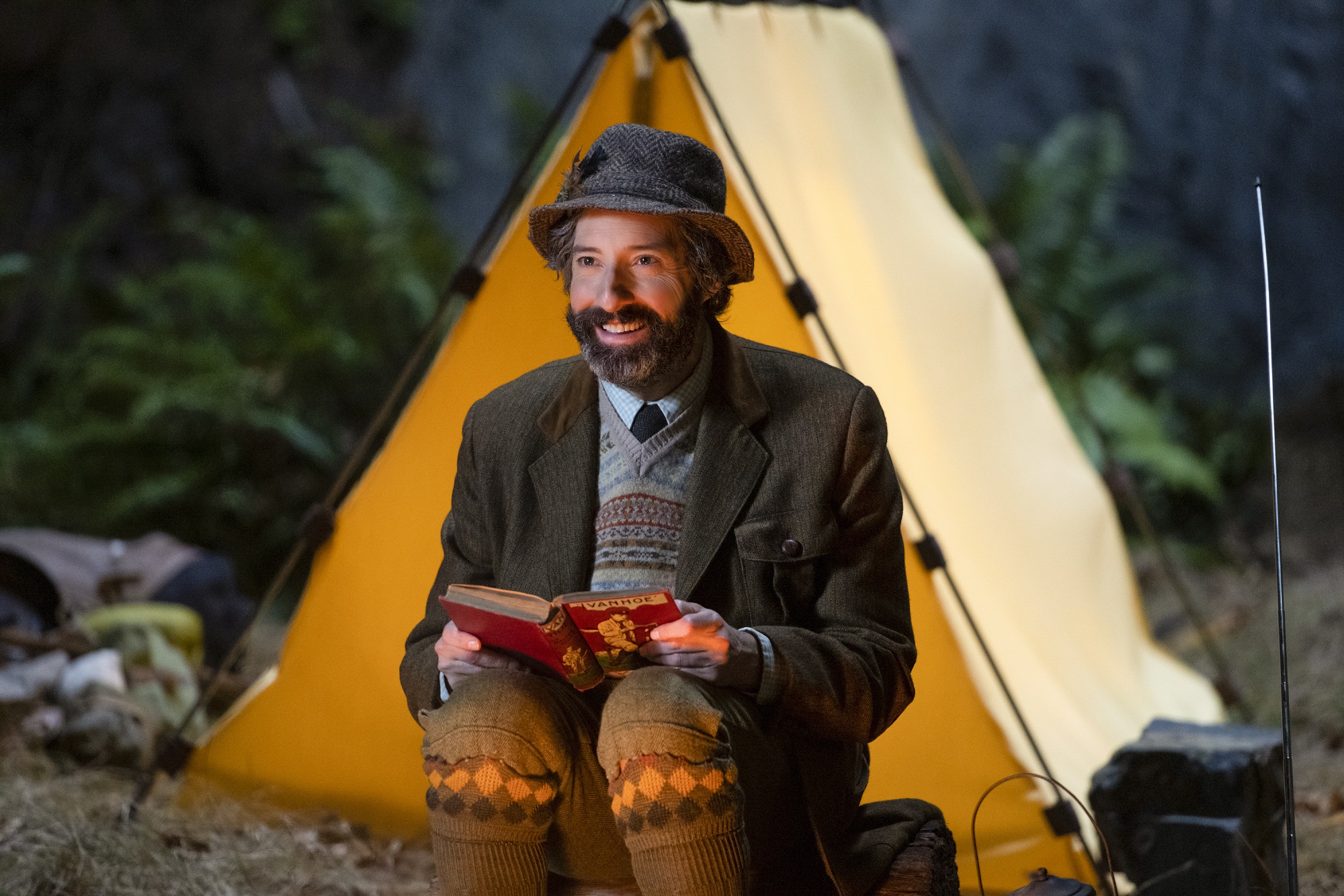 Mysterious Benedict Society: Mr. Benedict reads a book outside a tent