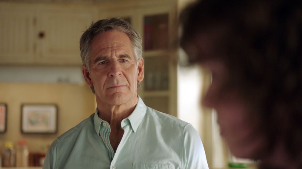 Scott Bakula as Special Agent Dwayne Pride looks on with concern. He's wearing a light blue shirt.