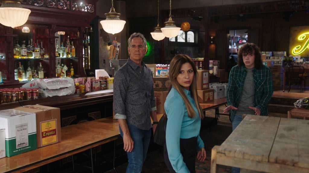 Scott Bakula as Special Agent Dwayne Pride, Callie Thorne as Sasha Broussard, and Drew Scheid as Connor Dean look concerned at Pride's bar.