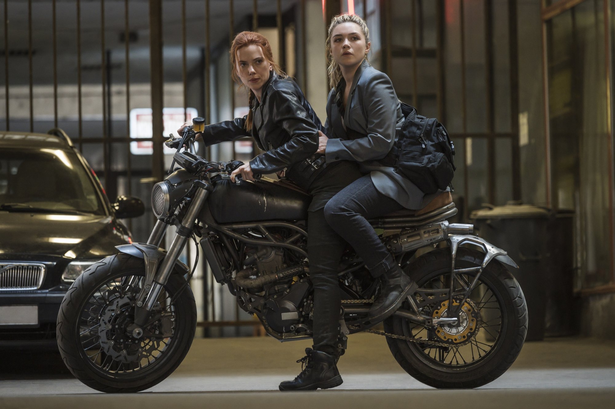 Natasha Romanoff (L) and Yelena Belova riding a motorcycle in 'Black Widow'