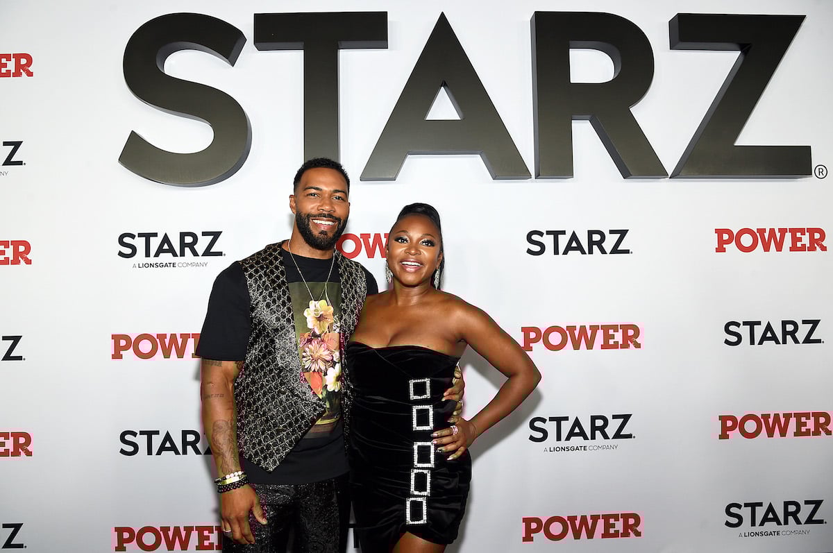 Omari Hardwick and Naturi Naughton smile for cameras