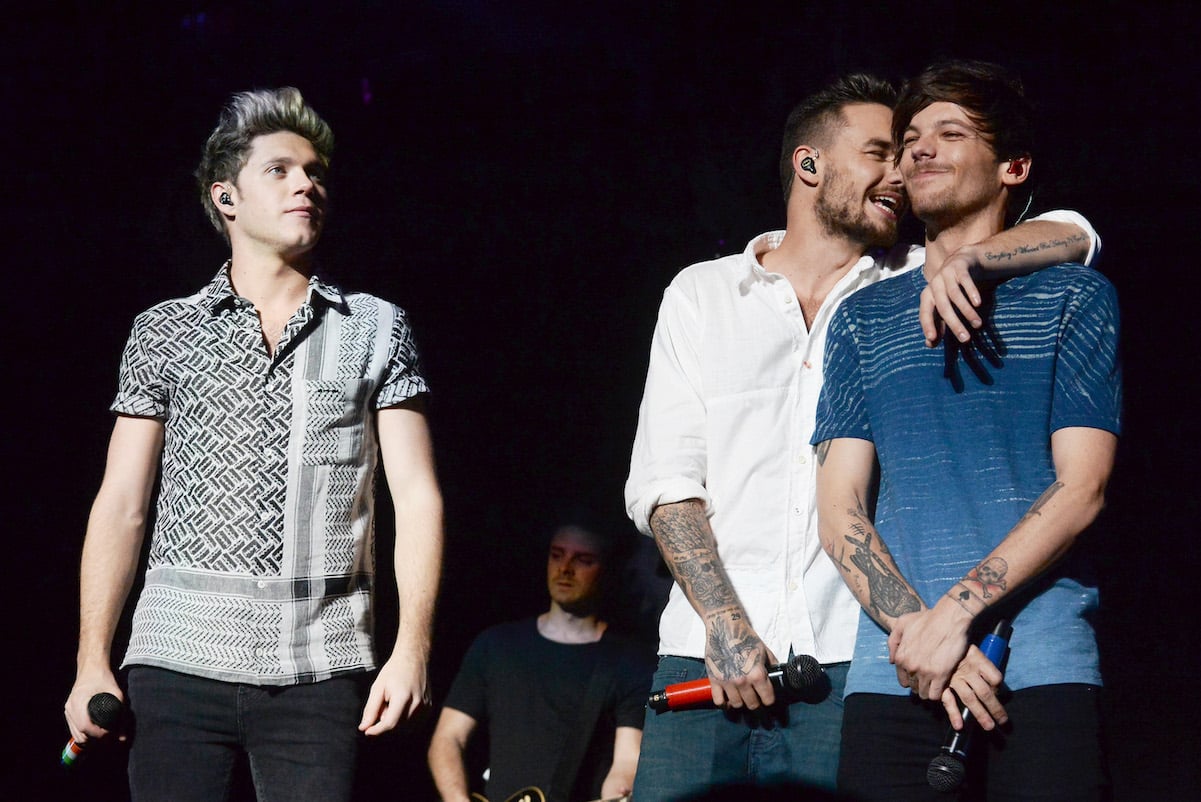Niall Horan with One Direction members Louis Tomlinson and Liam Payne on stage at a show