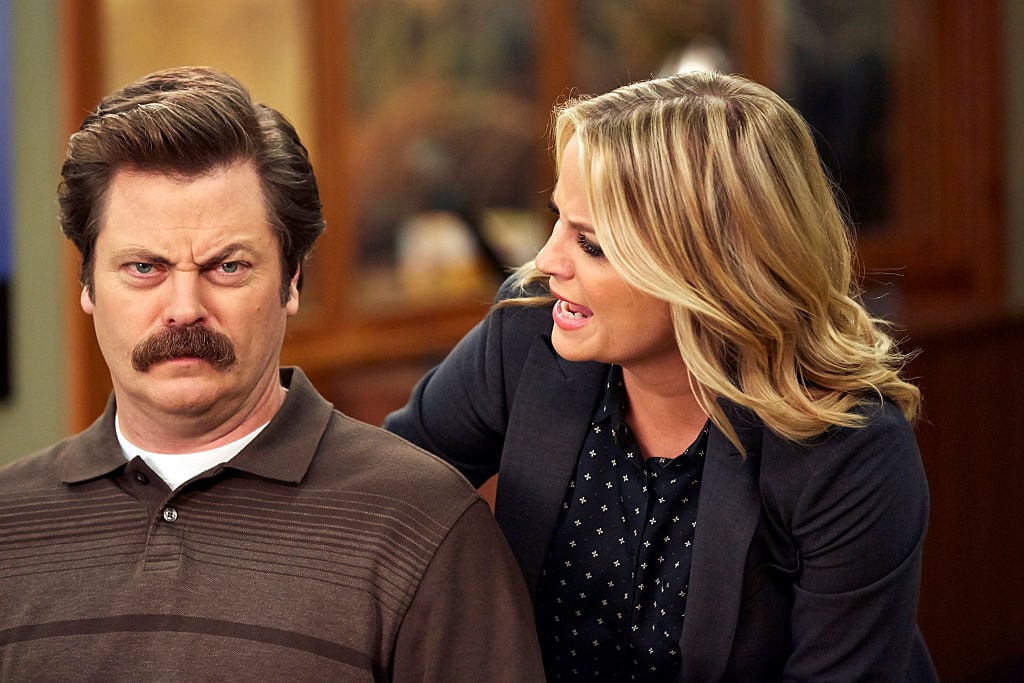 Amy Poehler as Leslie Knope yells at a stone-faced Nick Offerman as Ron Swanson.