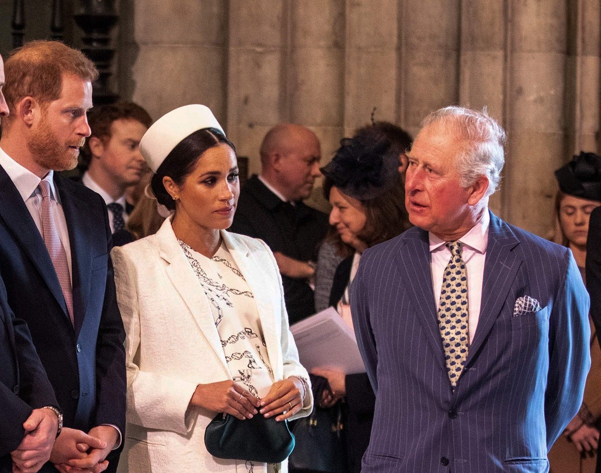 Prince Charles talking to Meghan Markle and Prince Harry as they all attend the Commonwealth Service