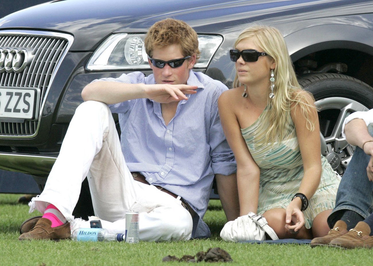 Prince Harry and Chelsy Davy sitting on grass together