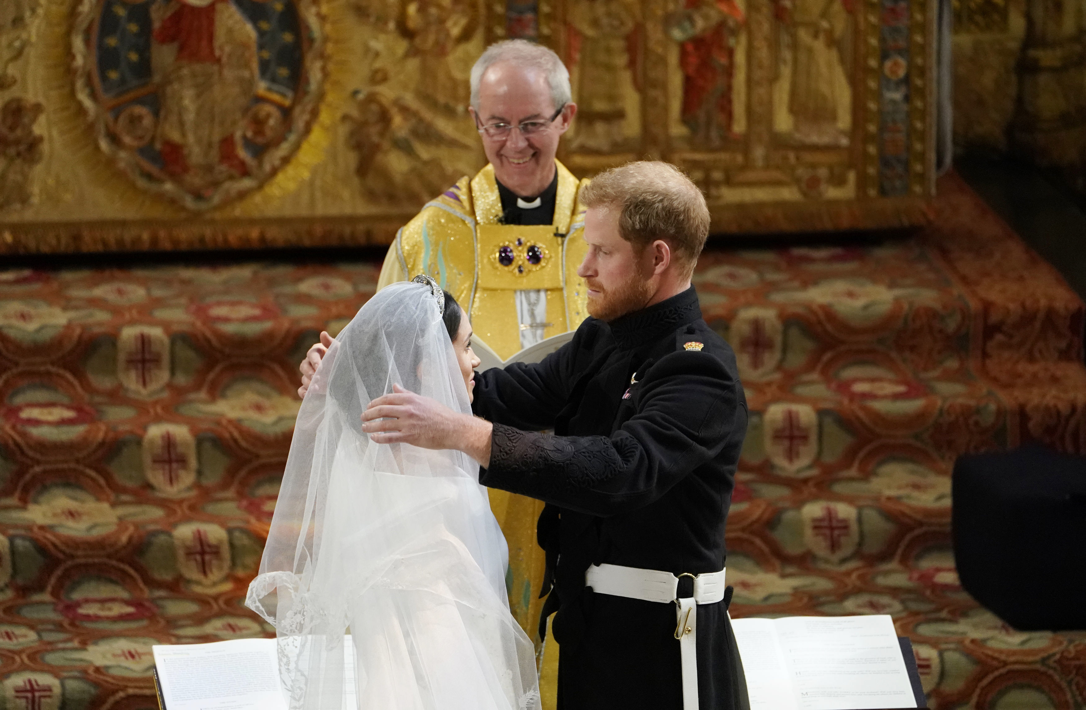 Prince Harry removes the veil of Meghan Markle at the altar before Archbishop of Canterbury Justin Welby