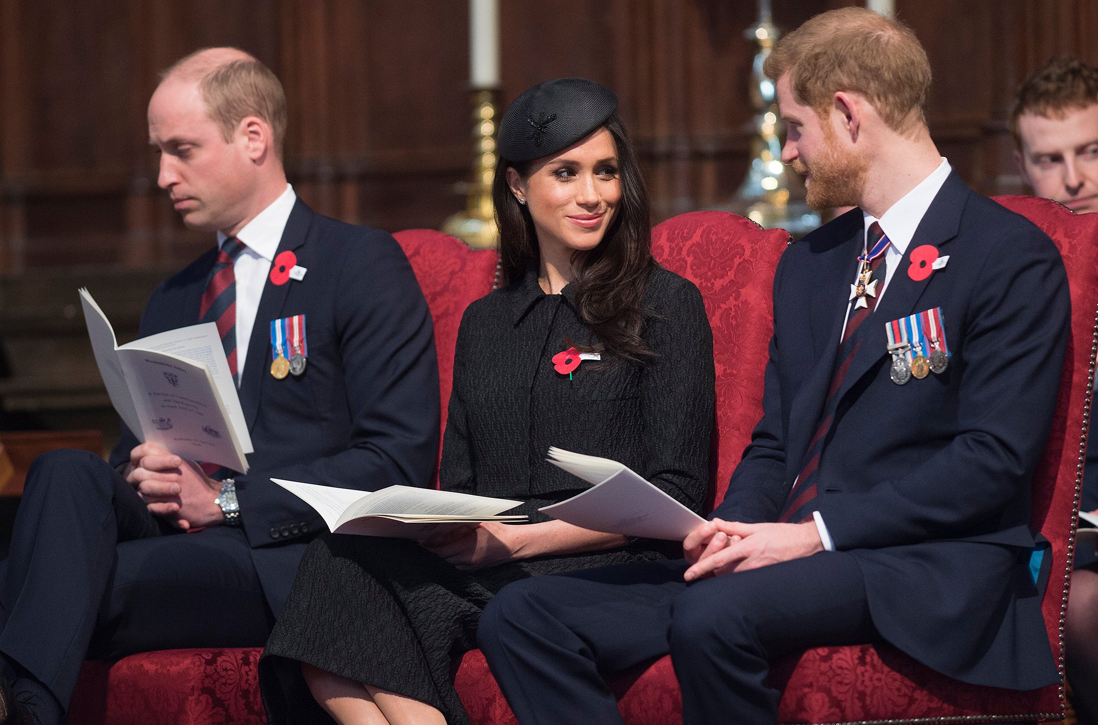 Prince William, Meghan Markle, and Prince Harry seated next to each other during an Anzac Day service at Westminster Abbey