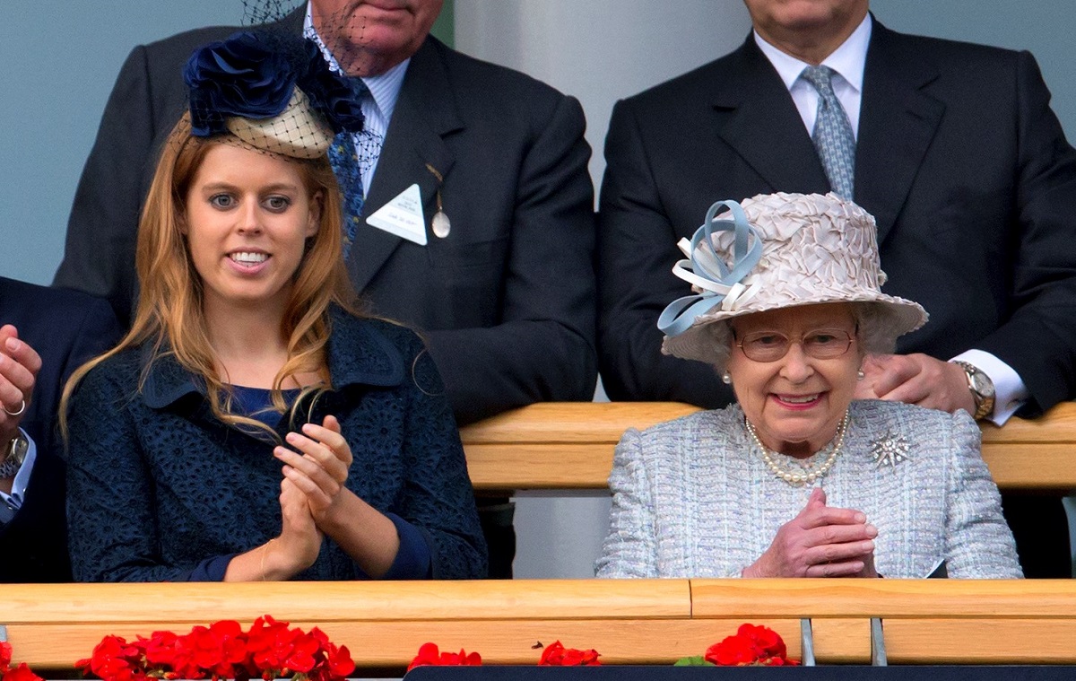 Princess Beatrice and Queen Elizabeth II clapping while in attendance at The QIPCO Champion Stakes