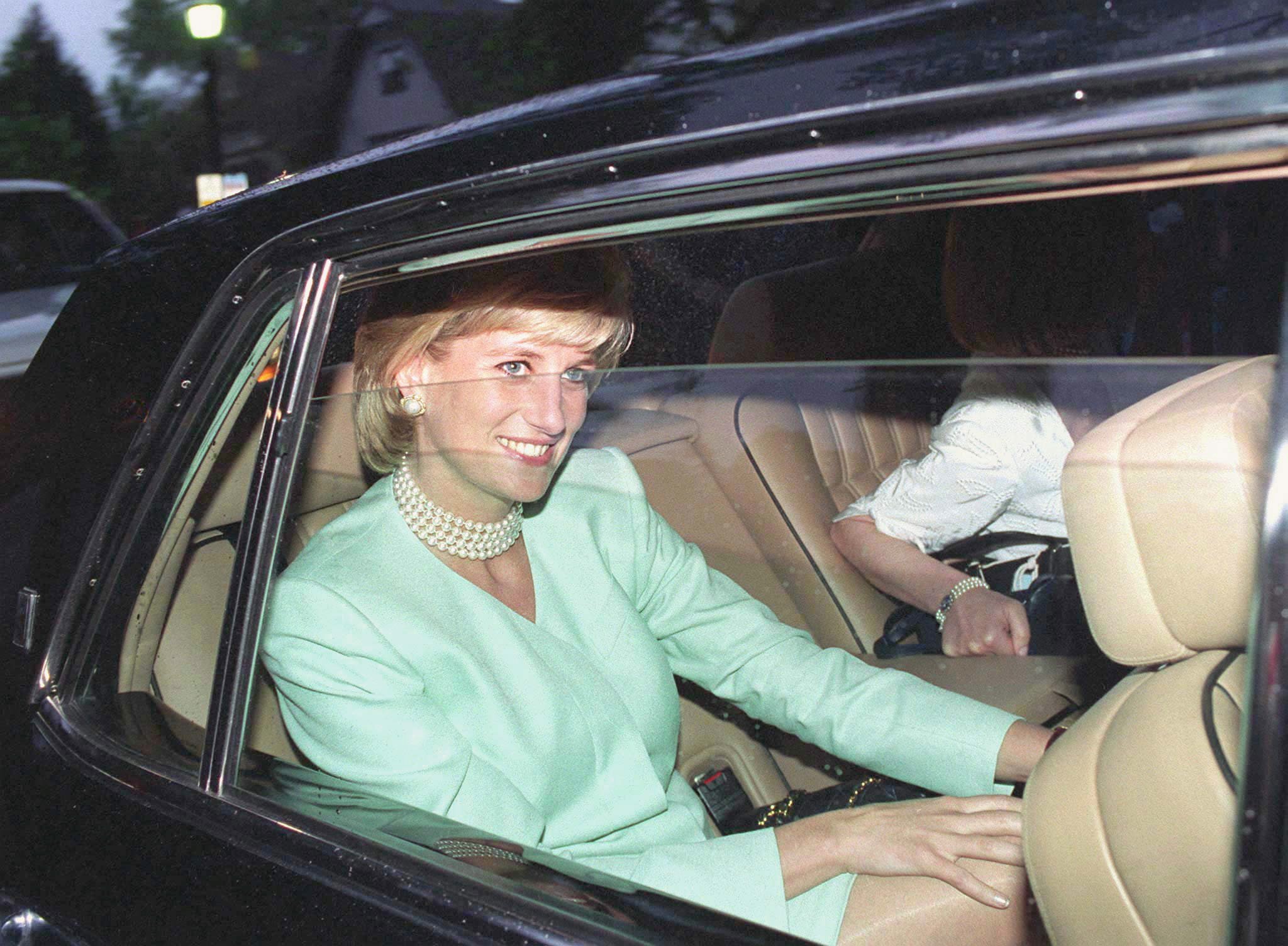 Princess Diana sitting in the back of a car during a trip to Chicago in 1996