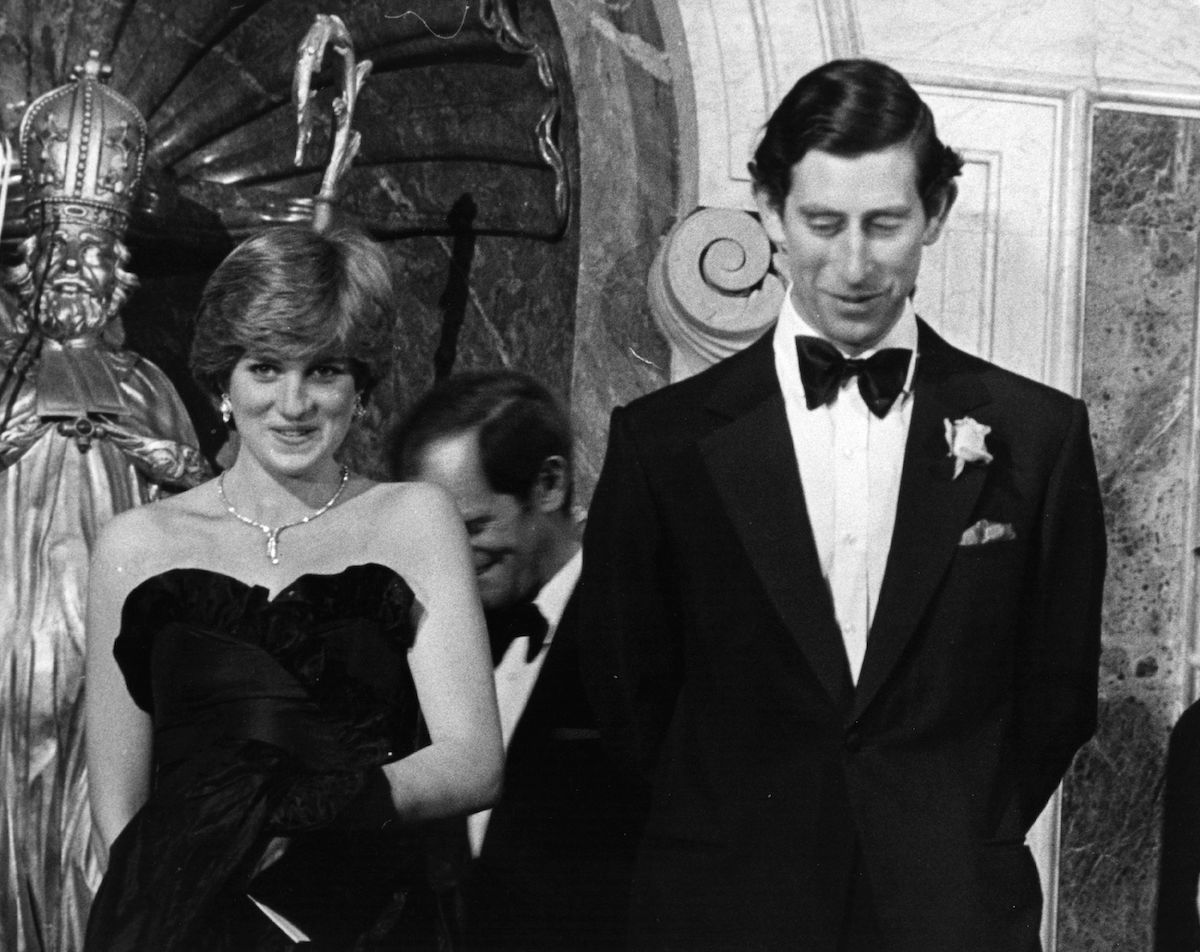 Princess Diana stands next to Prince Charles 