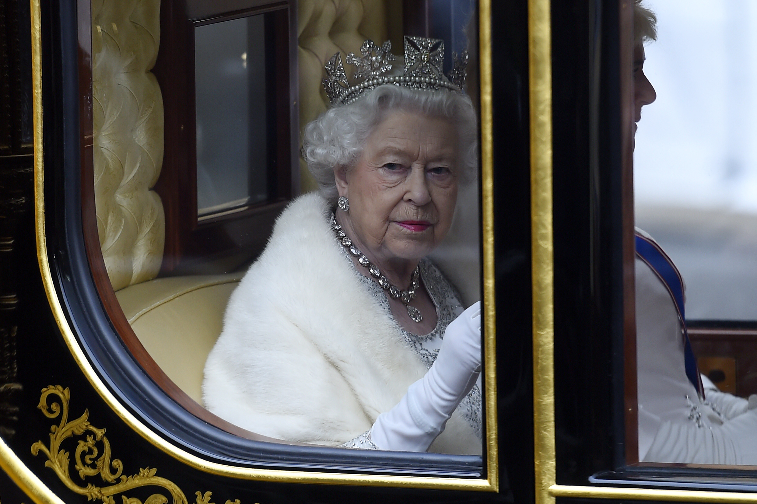 Queen Elizabeth II traveling in a carriage to State Opening Of Parliament