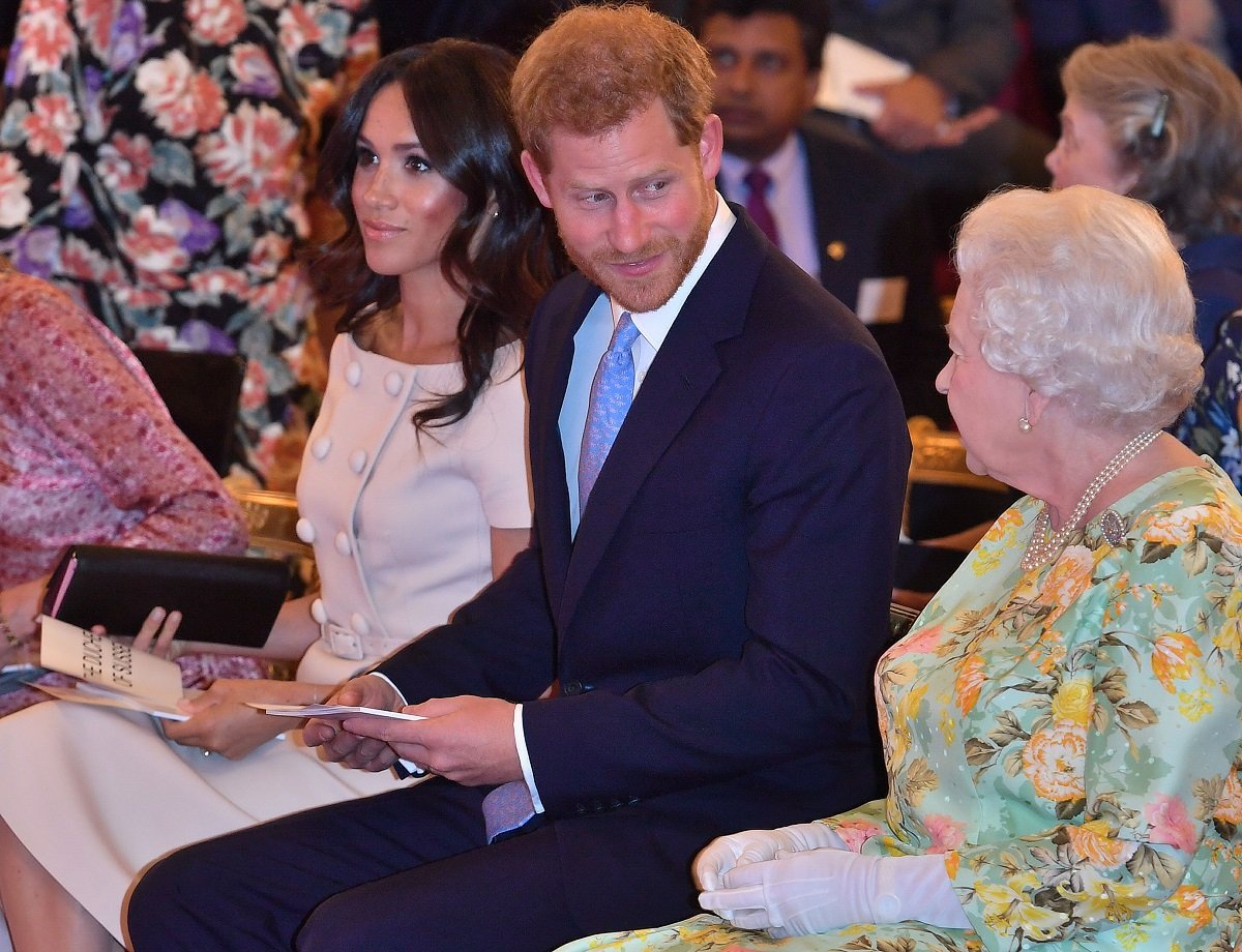 Queen Elizabeth II with Prince Harry, Duke of Sussex and Meghan, Duchess of Sussex at the Queen's Young Leaders Awards Ceremony at Buckingham Palace