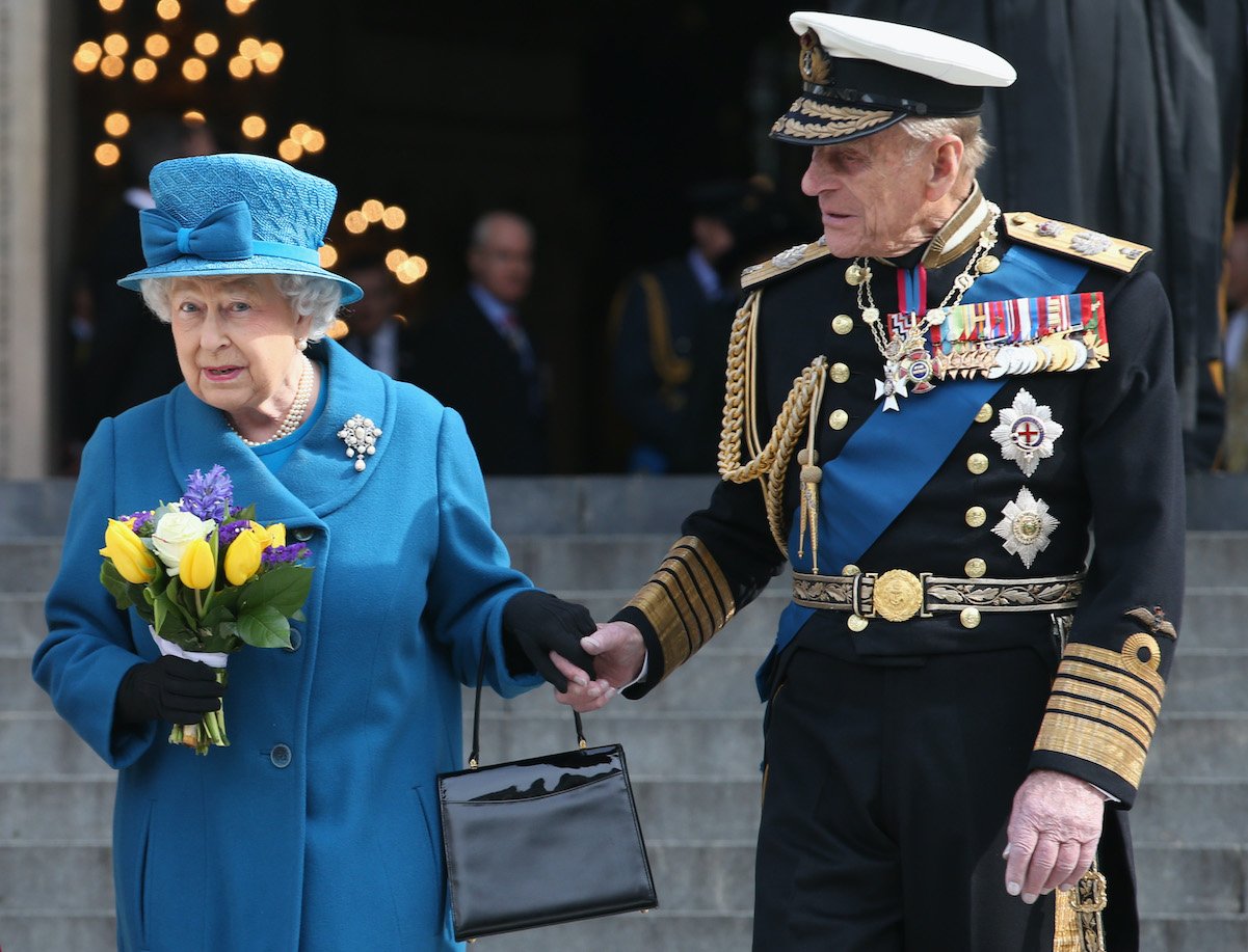 Queen Elizabeth and Prince Philip hold hands in 2015