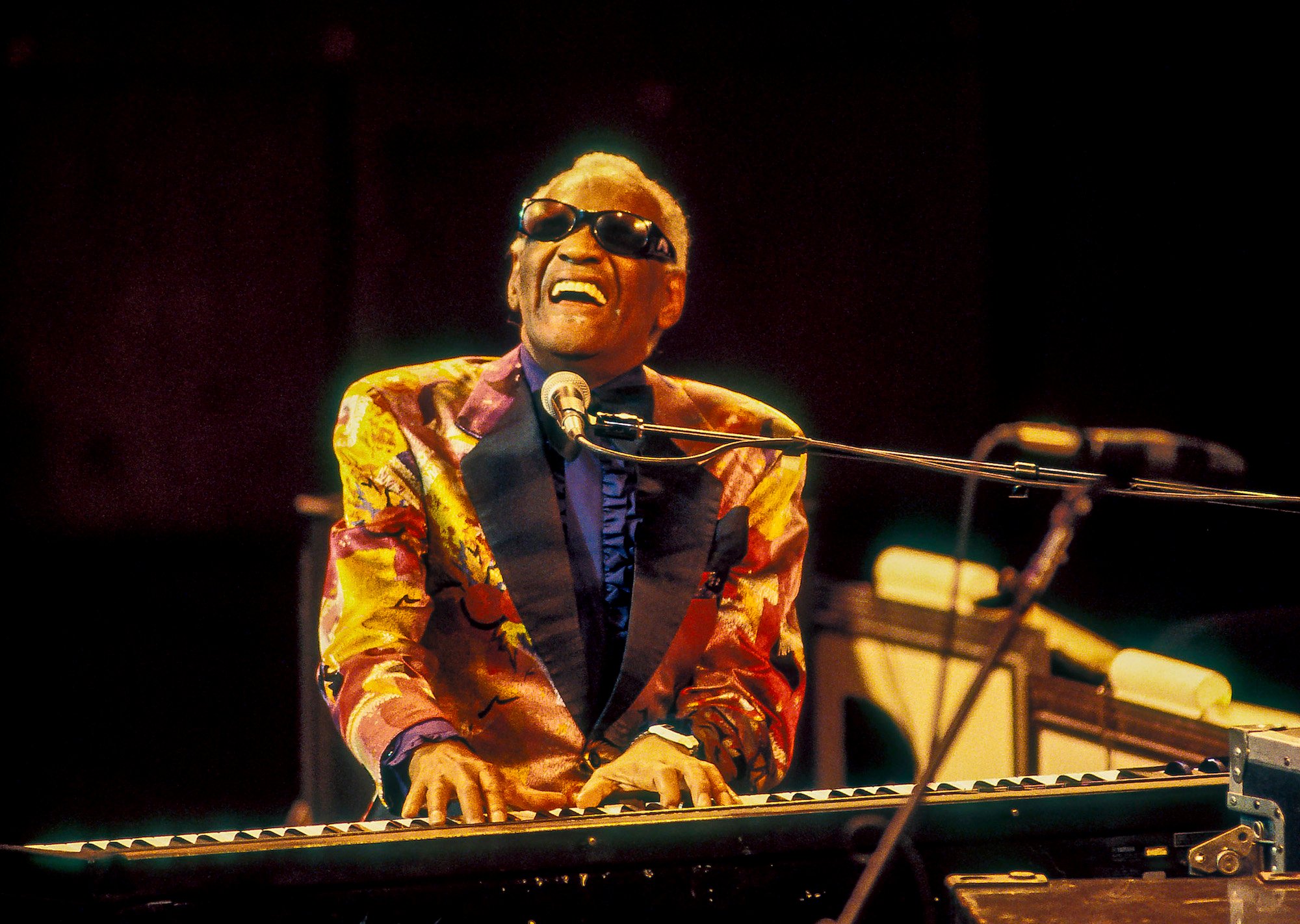 Ray Charles singing and playing on a keyboard