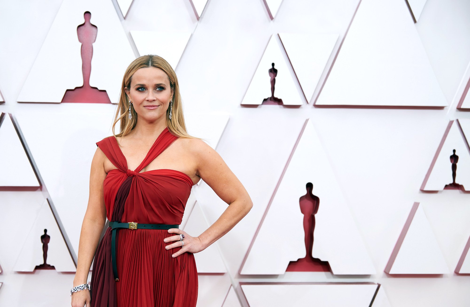 Reese Witherspoon smiling in front of a white background