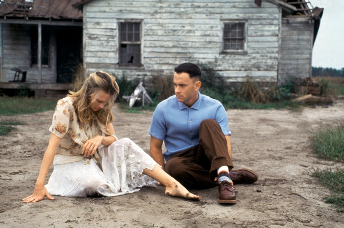 An emotional Jenny (Robin Wright) sits in front of a run-down house while Forrest (Tom Hanks) looks on in the movie ‘Forrest Gump’