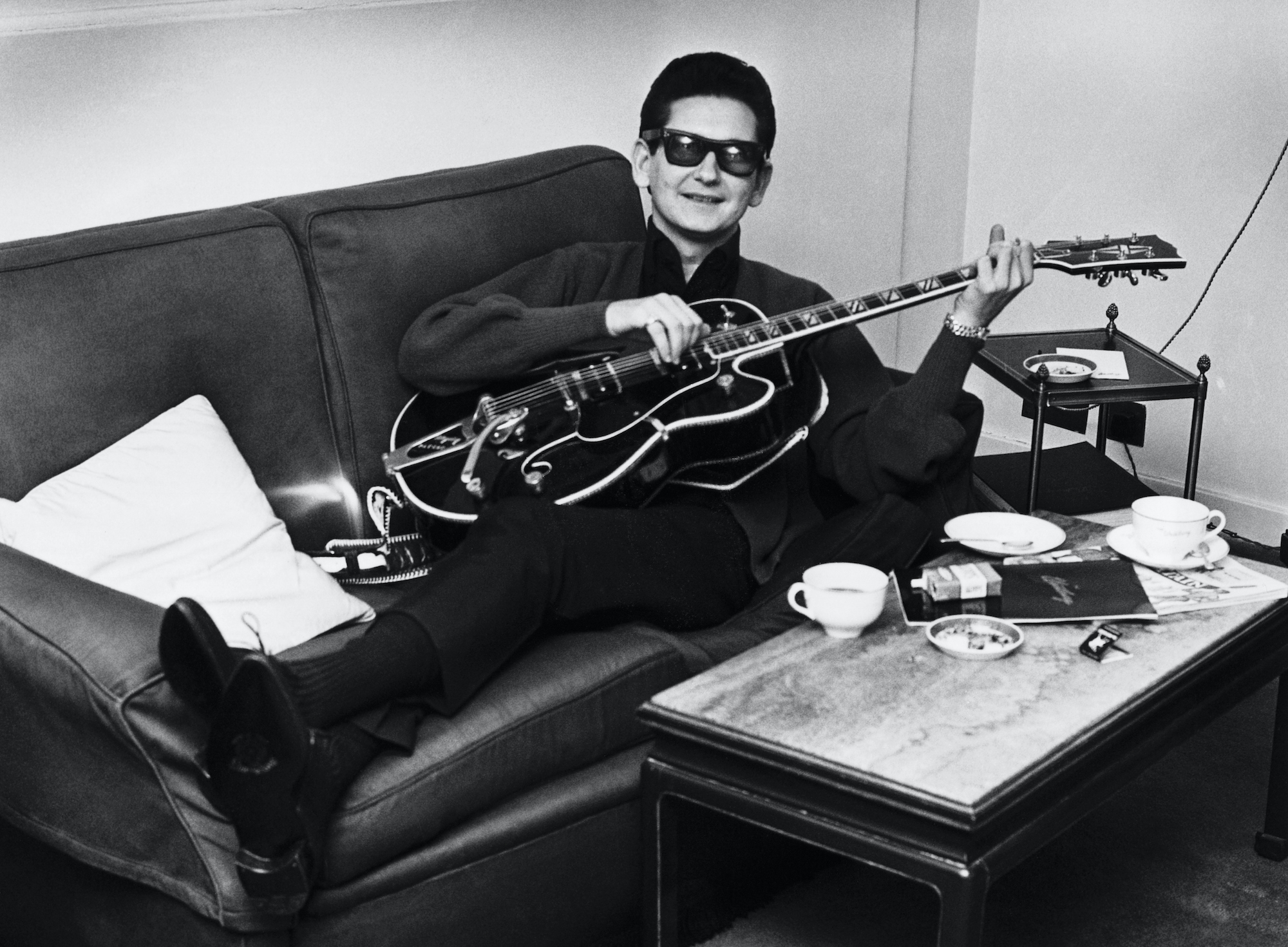 Roy Orbison With Guitar lying on a couch