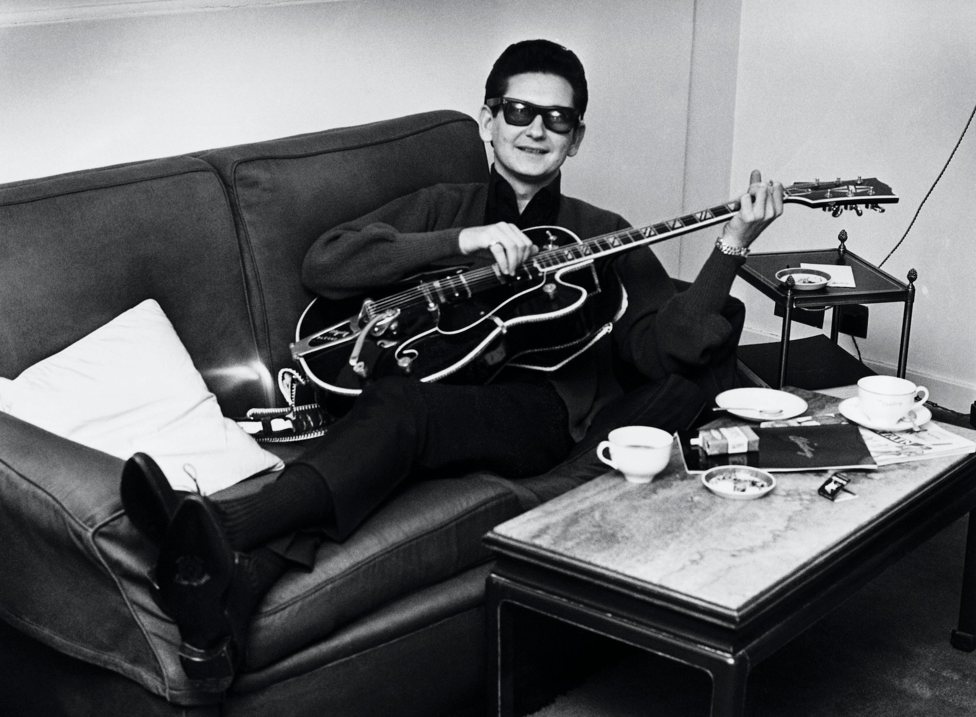 Roy Orbison With Guitar lying on a couch