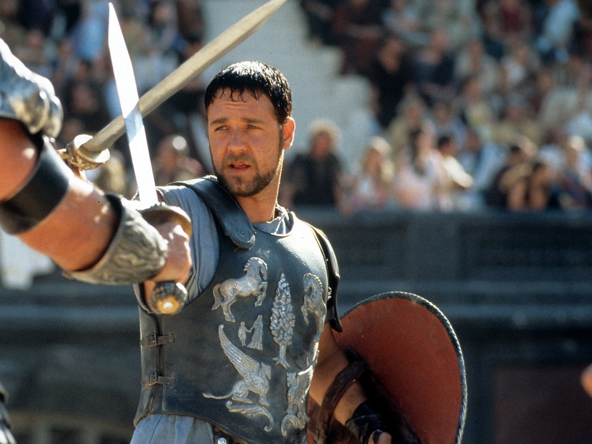 Russell Crowe facing off against another man in a scene from the film 'Gladiator', 2000.