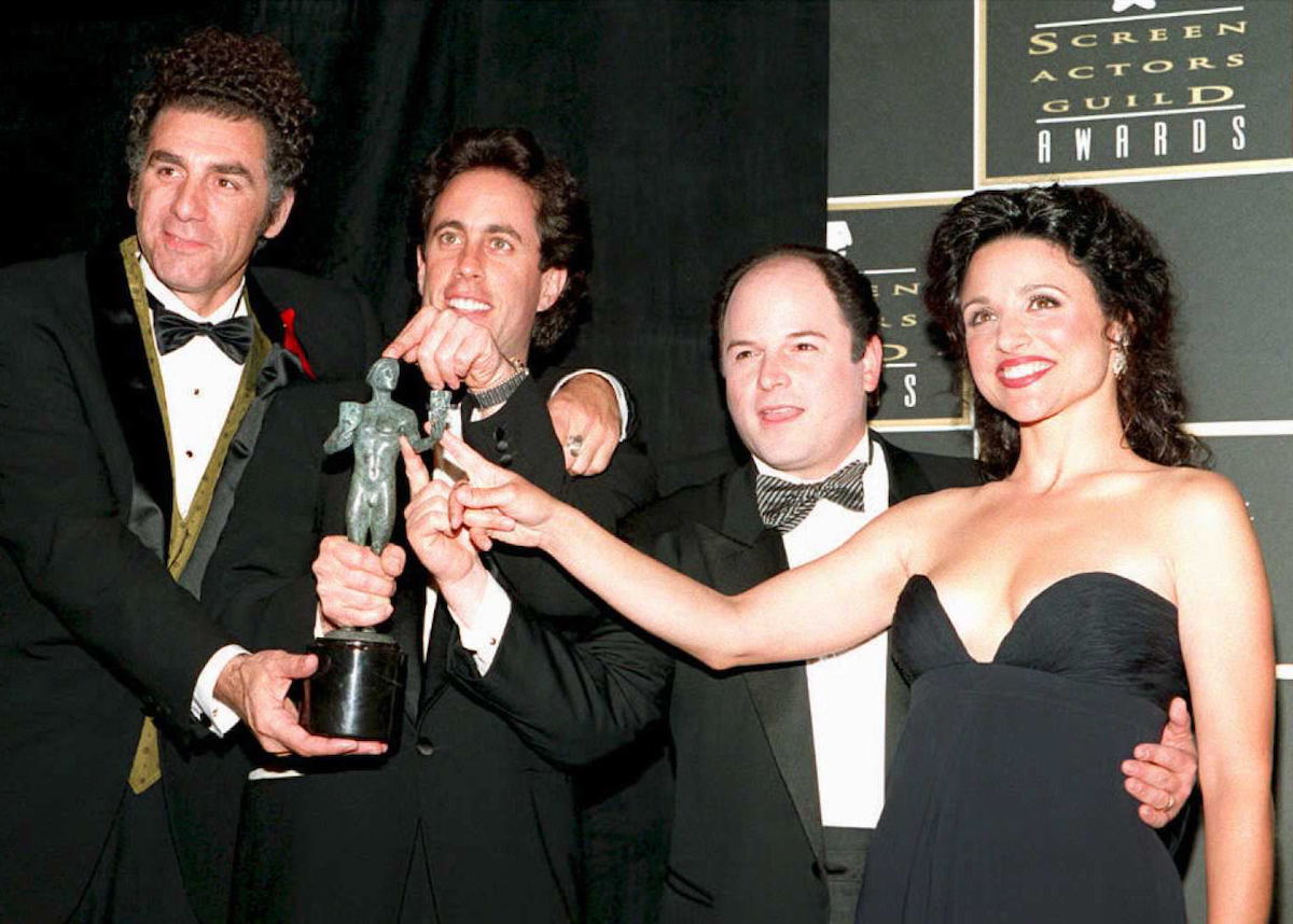 Michael Richards, Jerry Seinfeld, Jason Alexander, and Julia Louis-Dreyfus touch their Screen Actors Guild Award on a red carpet event