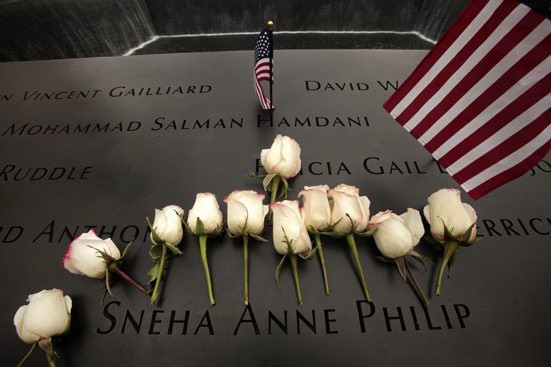 Flowers are placed on the plaque memoralizing Sneha Anne Philip at the World Trade Center site