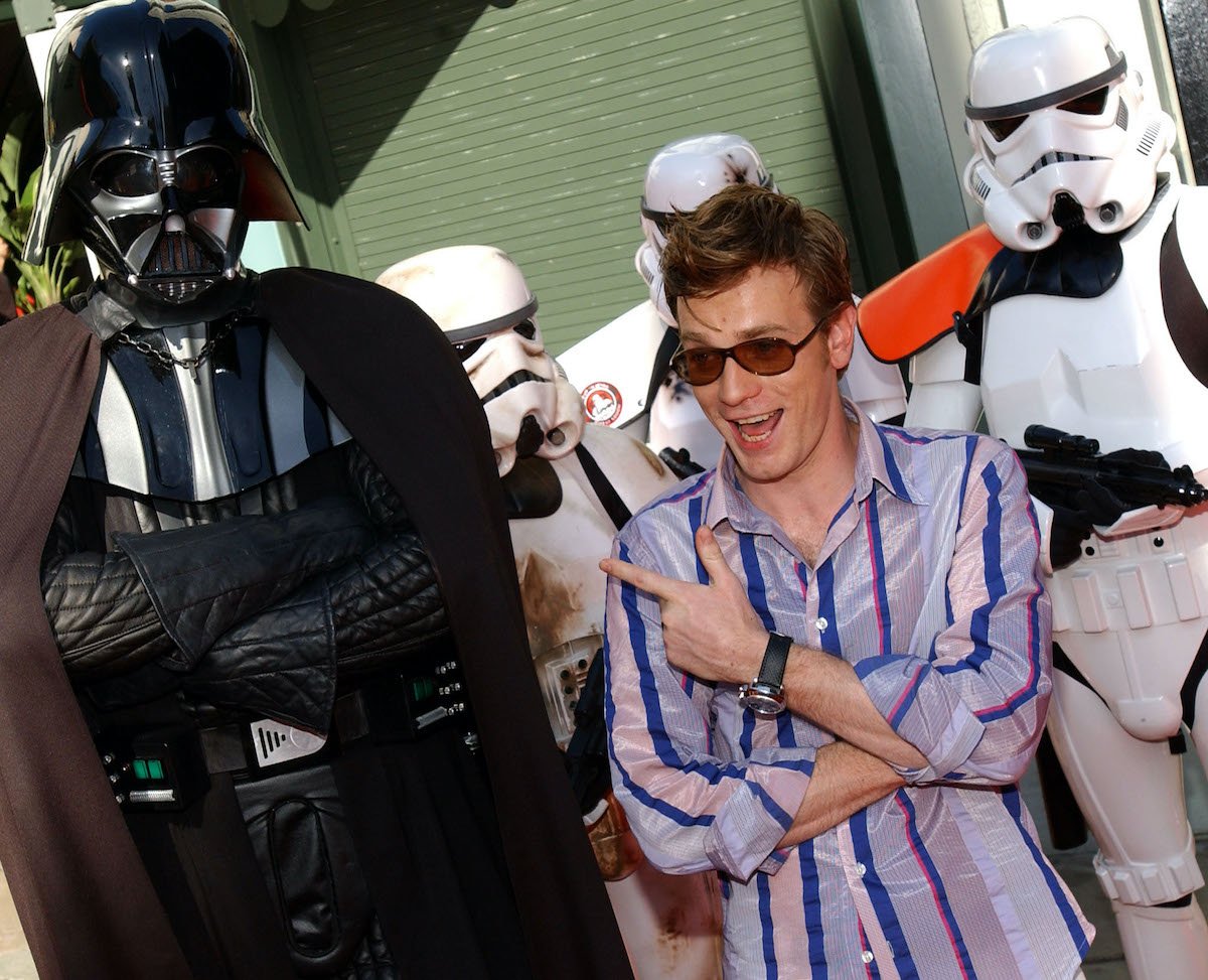 ‘Star Wars’ actor Ewan McGregor wears a striped shirt and poses next to a life-size Darth Vader and stormtroopers