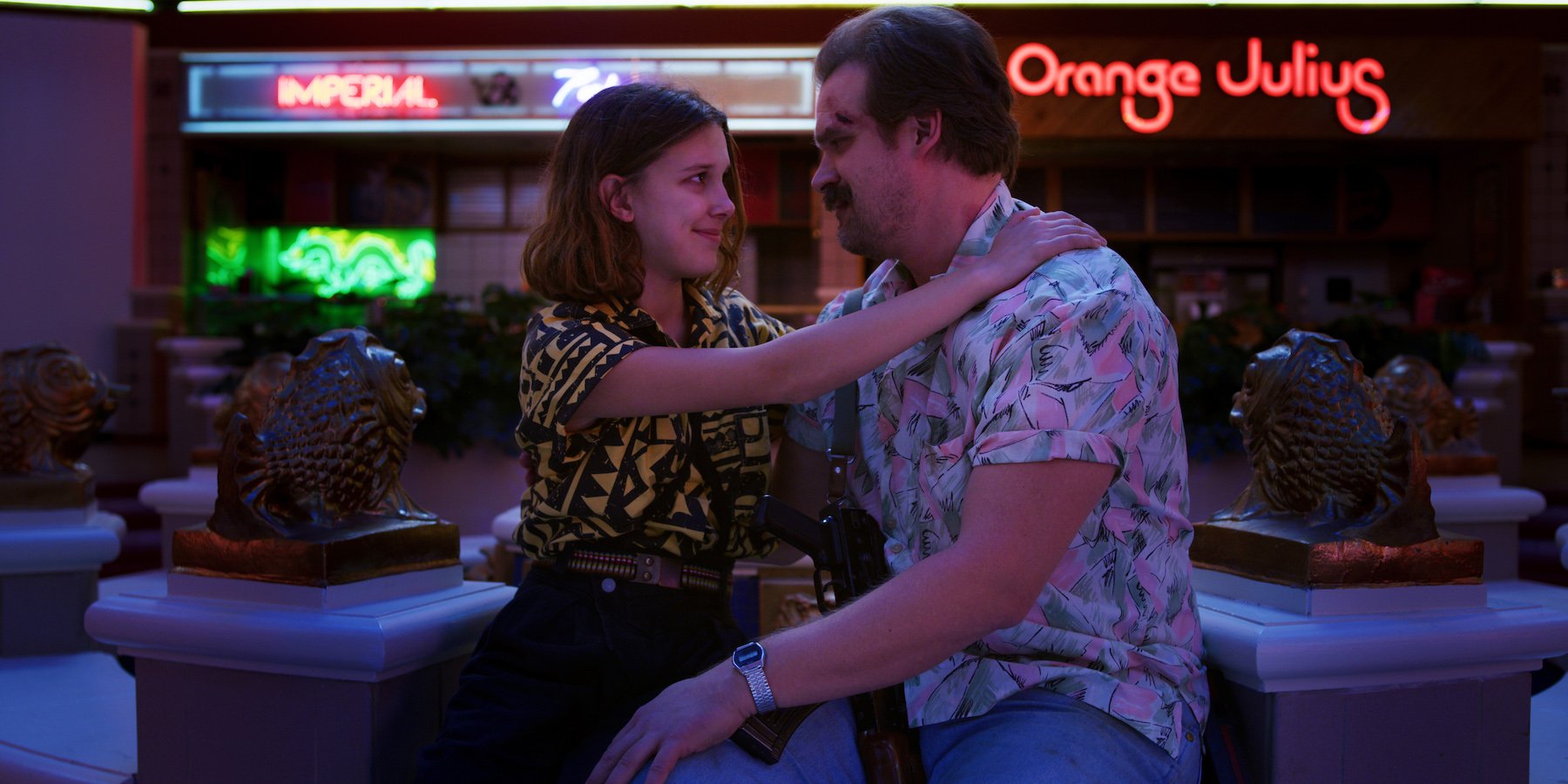 Millie Bobby Brown as Eleven hugging David Harbour as Jim Hopper in 'Stranger Things' Season 3. Both characters return in 'Stranger Things' Season 4