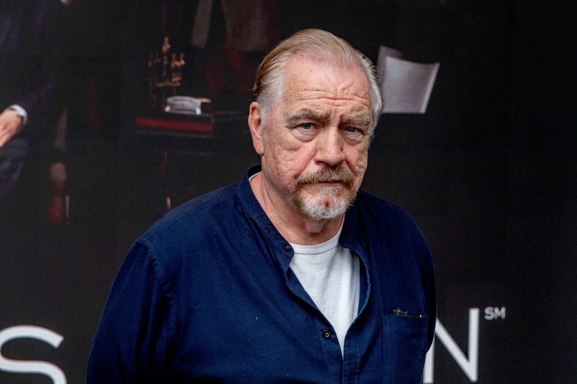 Brian Cox looking at the camera in front of a black background