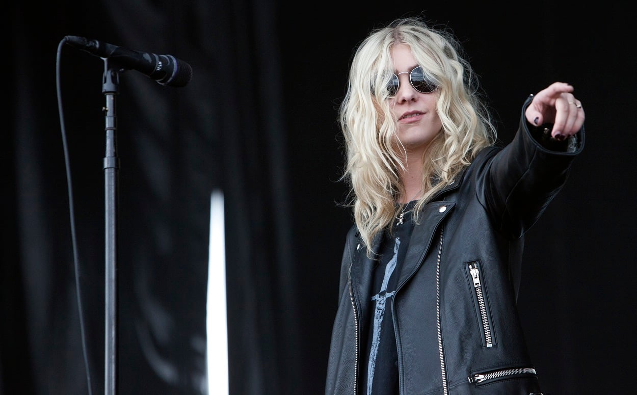 Gossip Girl alum Taylor Momsen performs in a black leather jacket and black sunglasses with her band, The Pretty Reckless