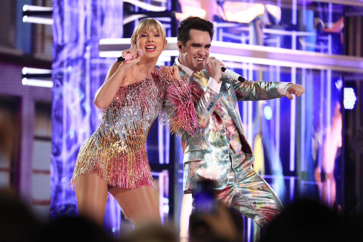 Taylor Swift in a rainbow dress performing with Brendon Urie