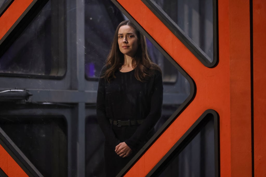Megan Boone as Liz Keen looks out from the box Reddington was in during the pilot episode.