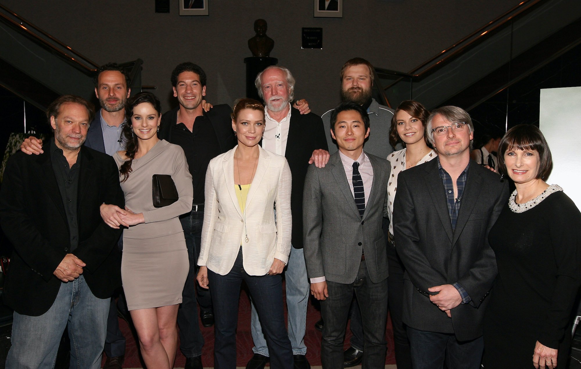 Cast and crew members of 'The Walking Dead' in front of staircases