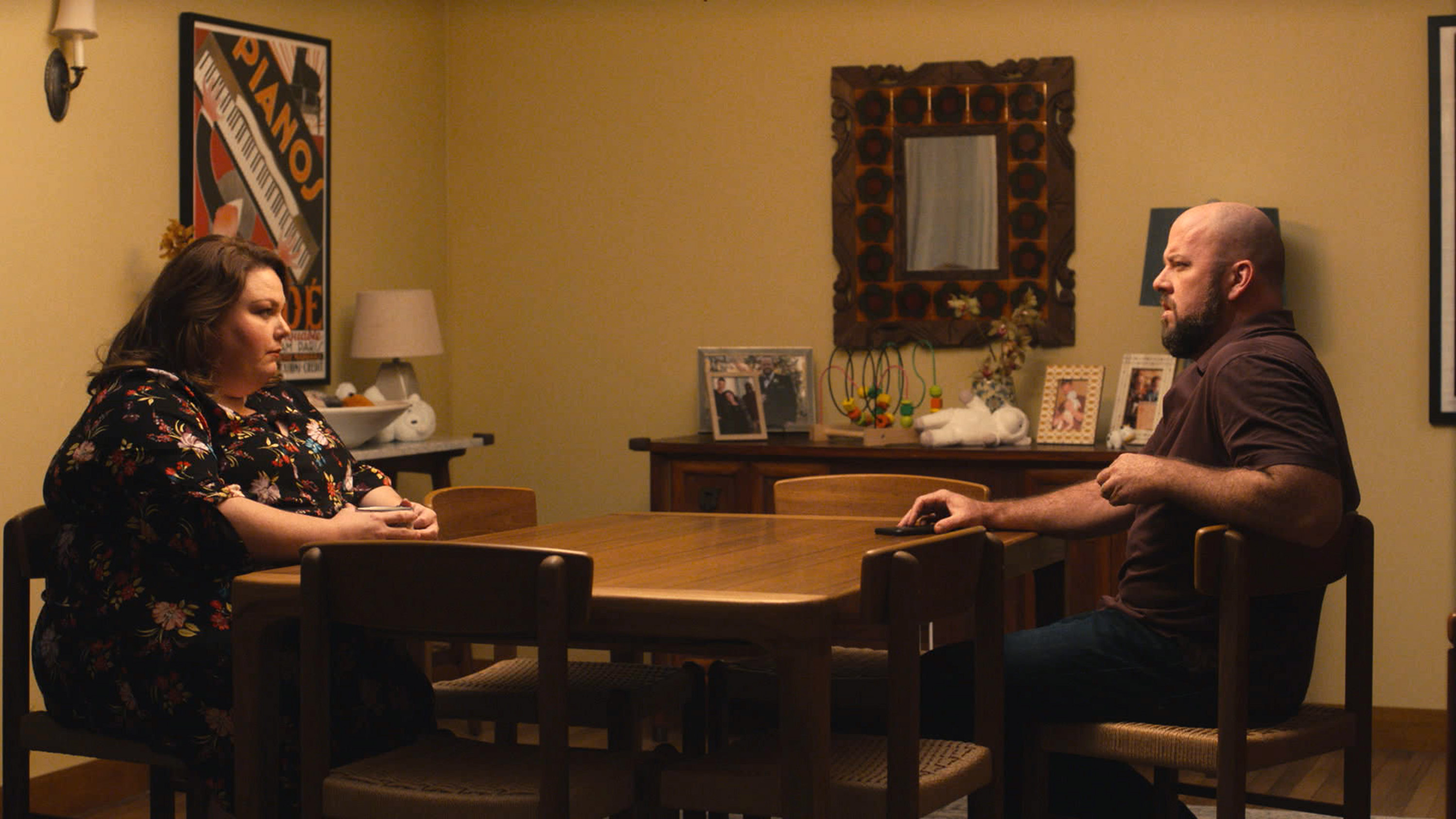'This Is Us' stars Chrissy Metz as Kate Pearson and Chris Sullivan as Toby staring at each other from across a table.