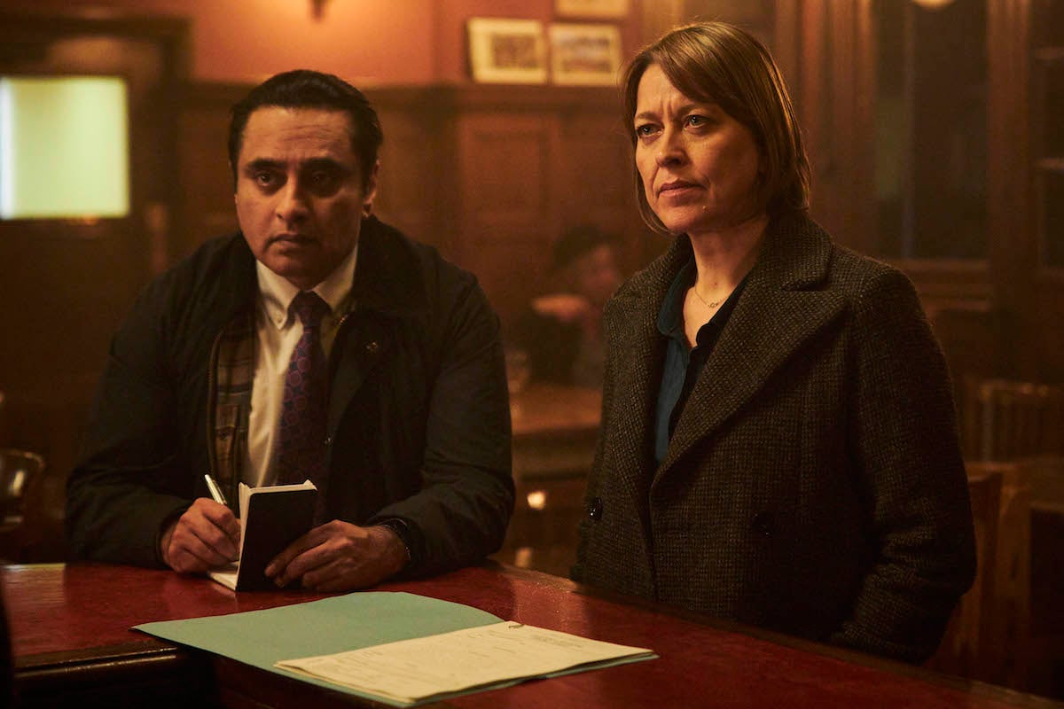 Sunny, taking notes, and Cassie standing at a bar in 'Unforgotten' Season 4