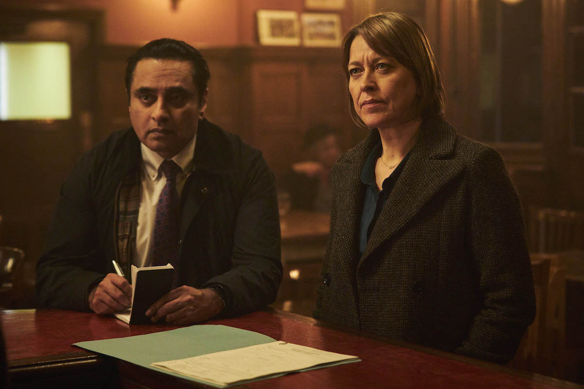 Sunny, taking notes, and Cassie standing at a bar in 'Unforgotten' Season 4