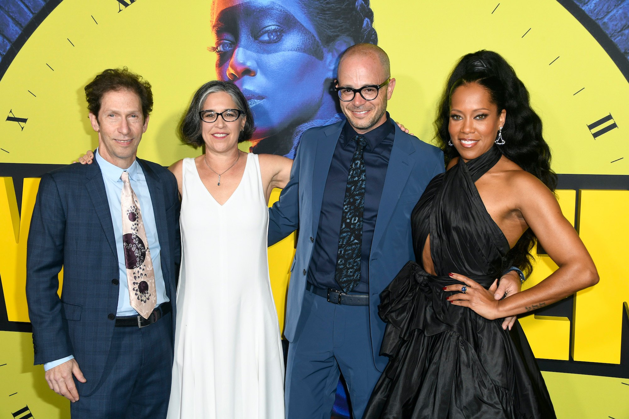 Creators and Cast of 'Watchmen' in front of a 'Watchmen' logo