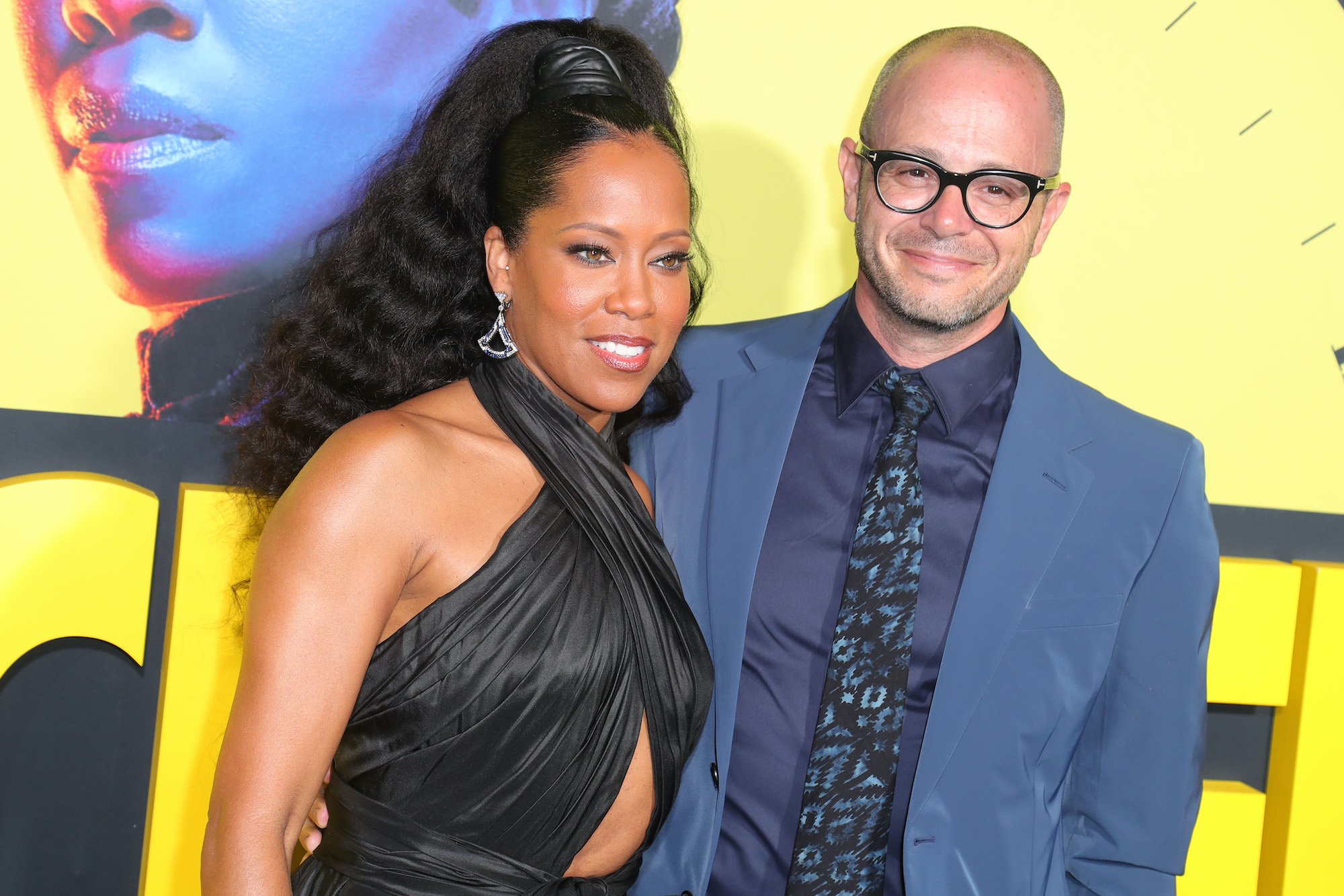 Regina King and Damon Lindelof smiling in front of a 'Watchmen' logo