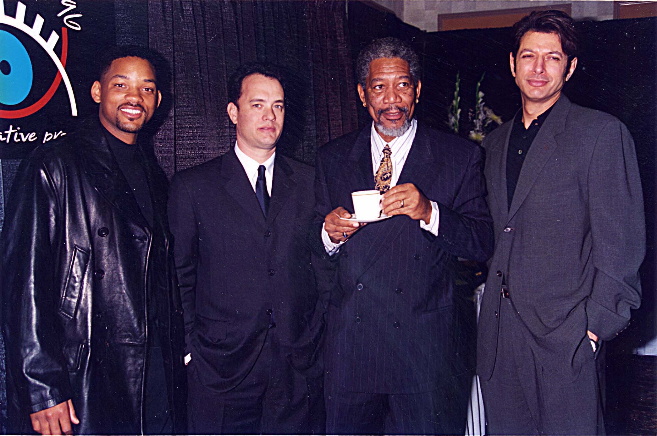 Will Smith, Tom Hanks, Morgan Freeman, and Jeff Goldblum, a few actors from 'Independence Day,' standing in suits together