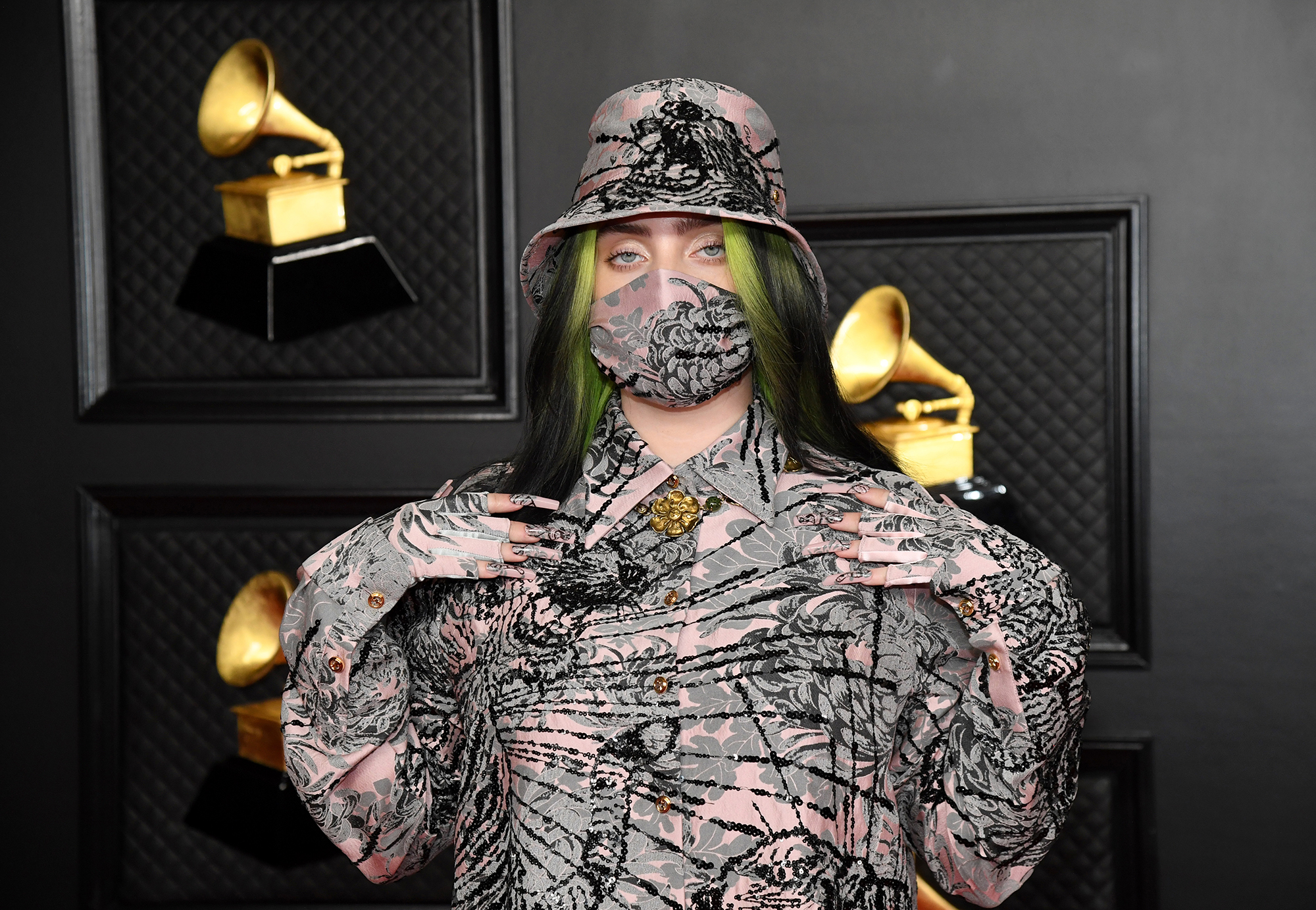 Billie Eilish poses with her hands on her shoulders at the 63rd Annual Grammy Awards in Los Angeles, California.