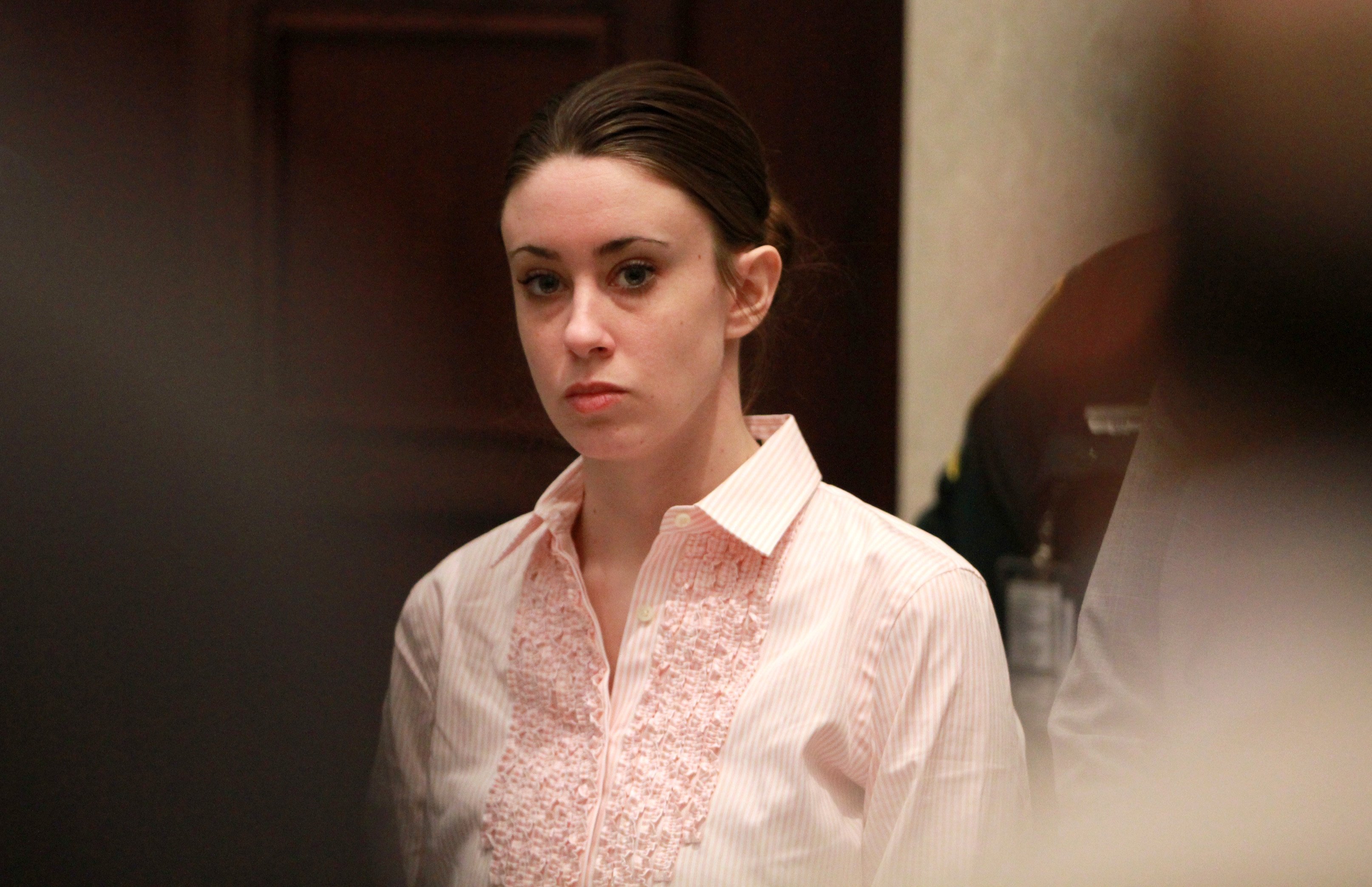 Casey Anthony wearing a pink ruffled blouse during her murder trial