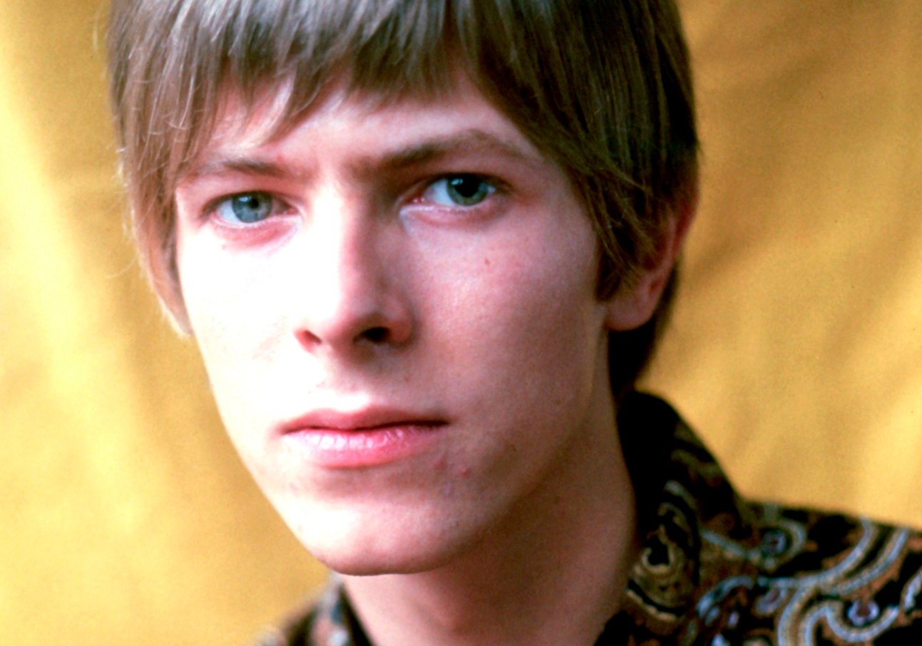 David Bowie stares into the camera for a closeup portrait photo in 1967.