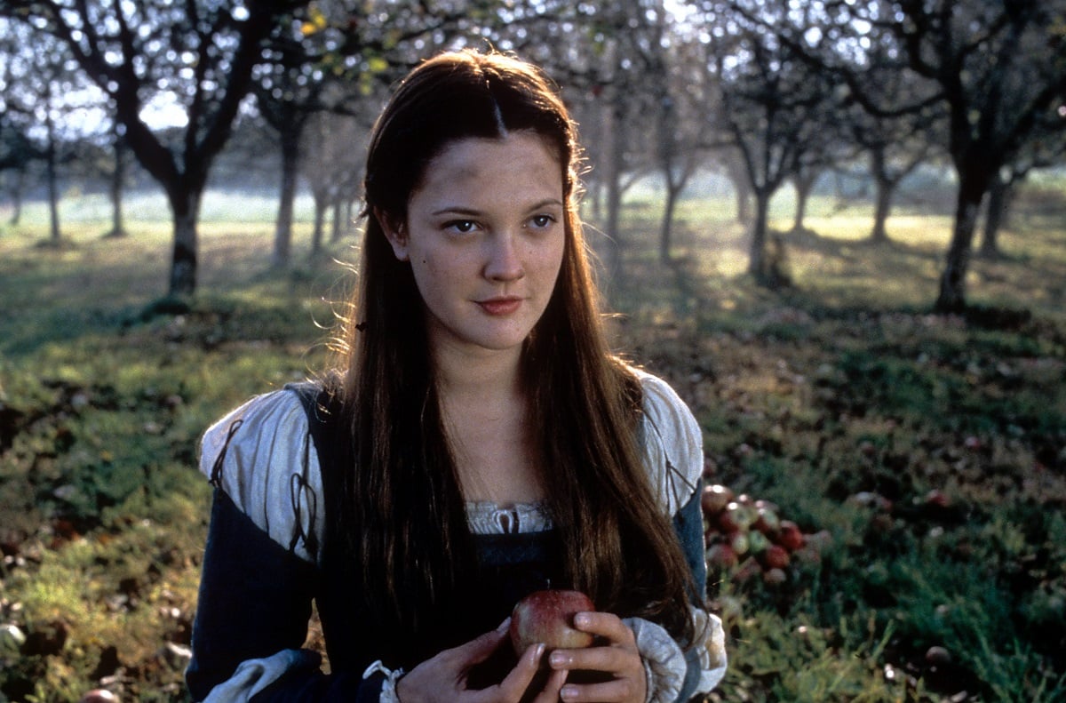 Drew Barrymore holding an apple in a scene from the film 'Ever After: A Cinderella Story,' 1998.