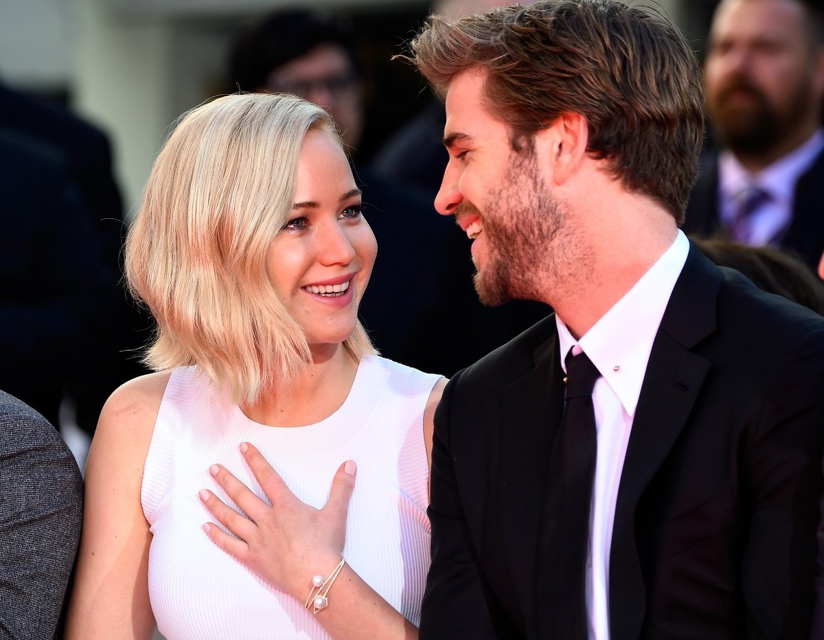 Jennifer Lawrence (L) and Liam Hemsworth on October 31, 2015 in Hollywood, California.