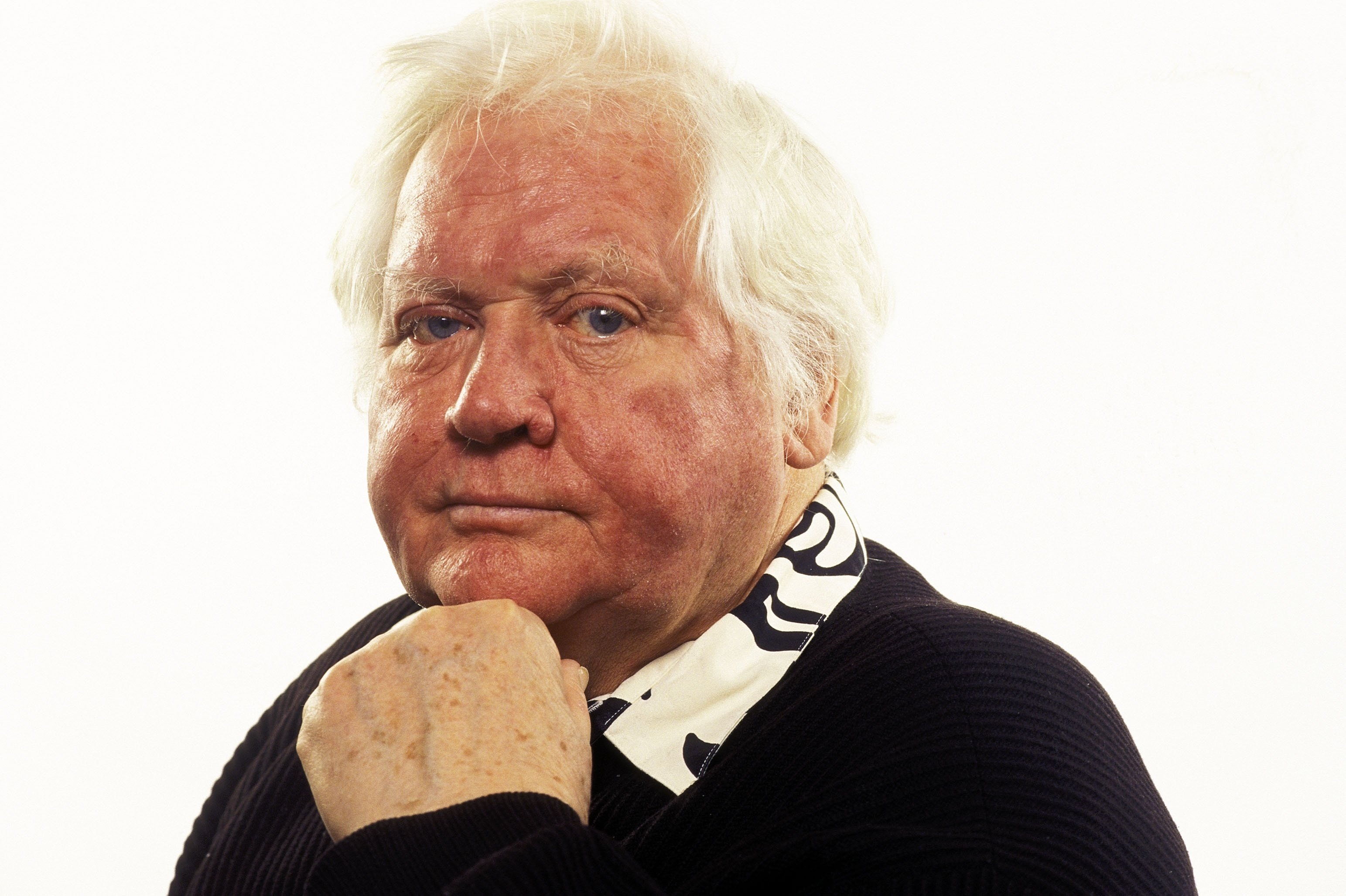 Ken Russell, the director of The Who's Tommy, with a white backdrop