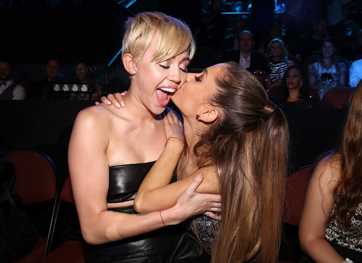 Miley Cyrus (L) and Ariana Grande attend the 2014 MTV Video Music Awards on August 24, 2014, in Inglewood, California.