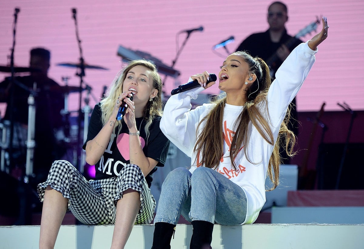 Ariana Grande (R) and Miley Cyrus perform on stage during the One Love Manchester Benefit Concert on June 4, 2017, in Manchester, England. 