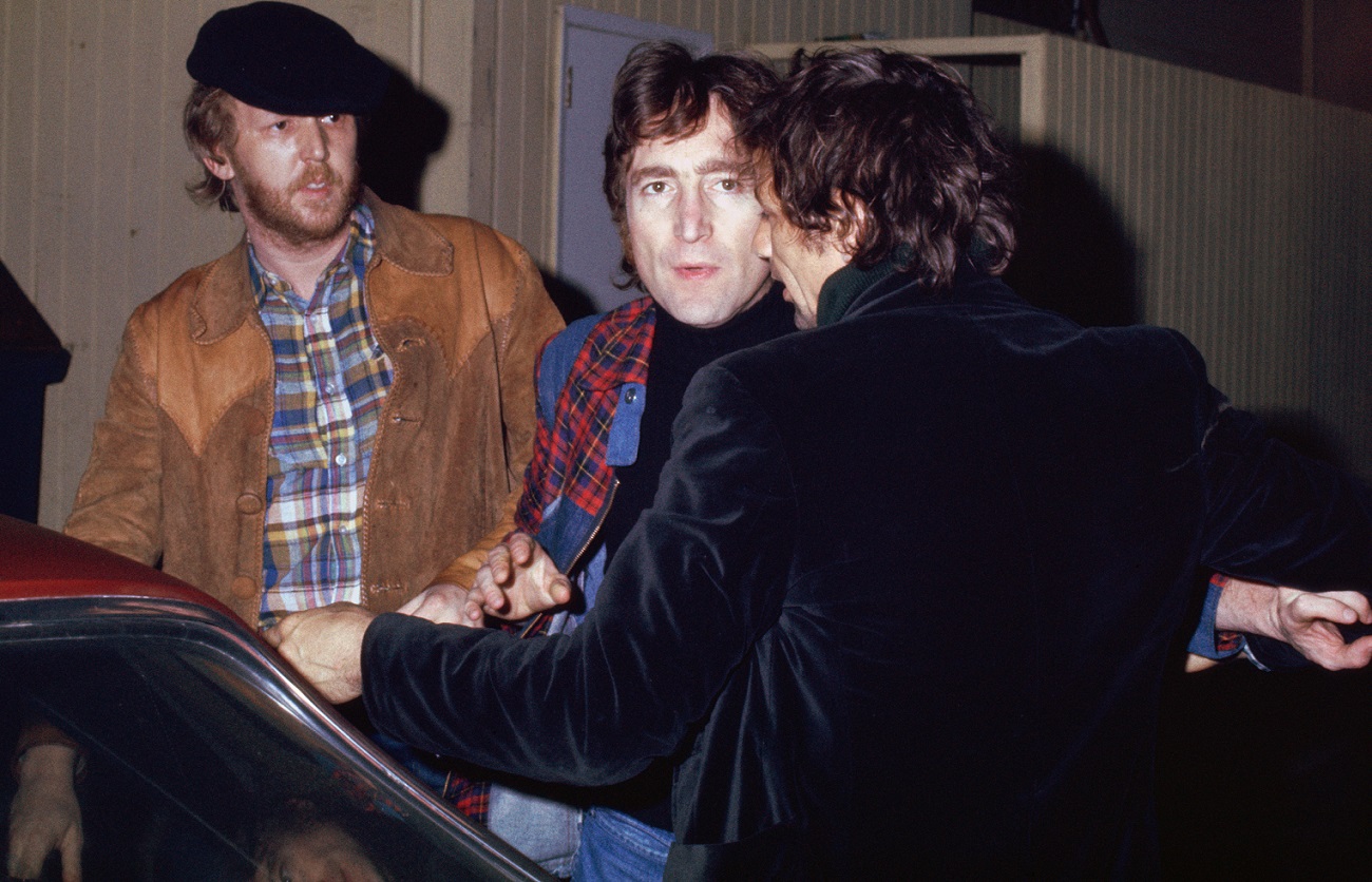 Harry Nilsson and John Lennon getting kicked out of the Troubadour club in 1974. Lennon stares at the camera as an unidentified man tries to get him into a car.