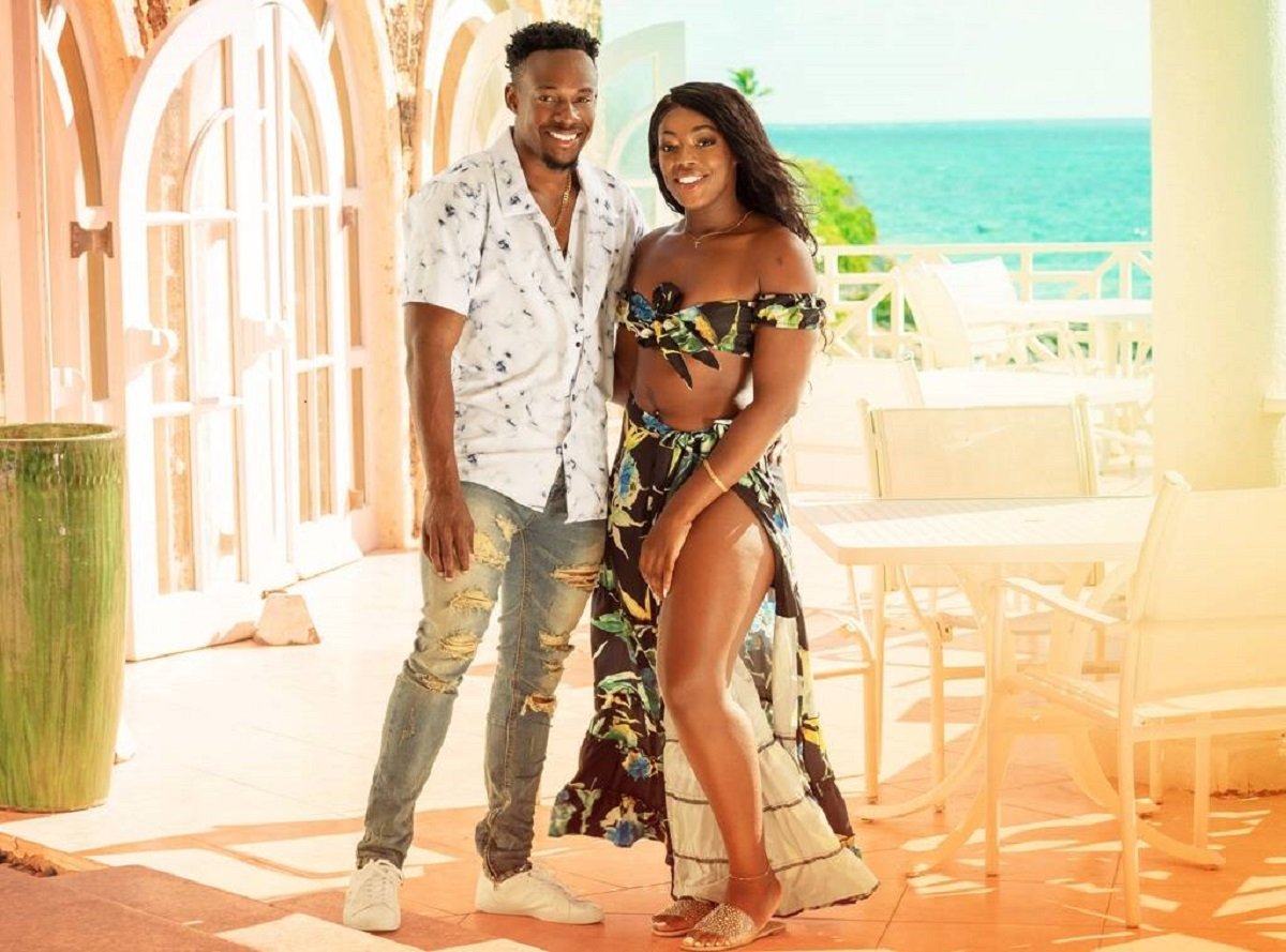 Steven and Martine posing in front of the beach on Love in Paradise: The Caribbean, A 90 Day Story | discovery+