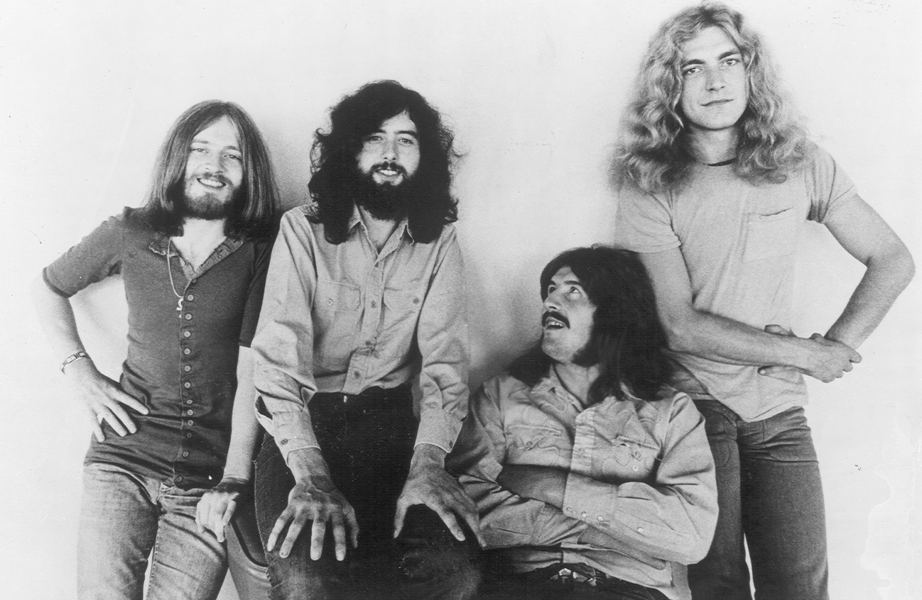 Led Zeppelin smiles and poses for the camera in an early band photo.